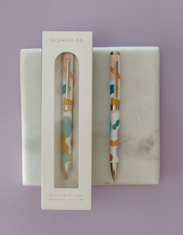 Two colorful pens in a display box on a purple background