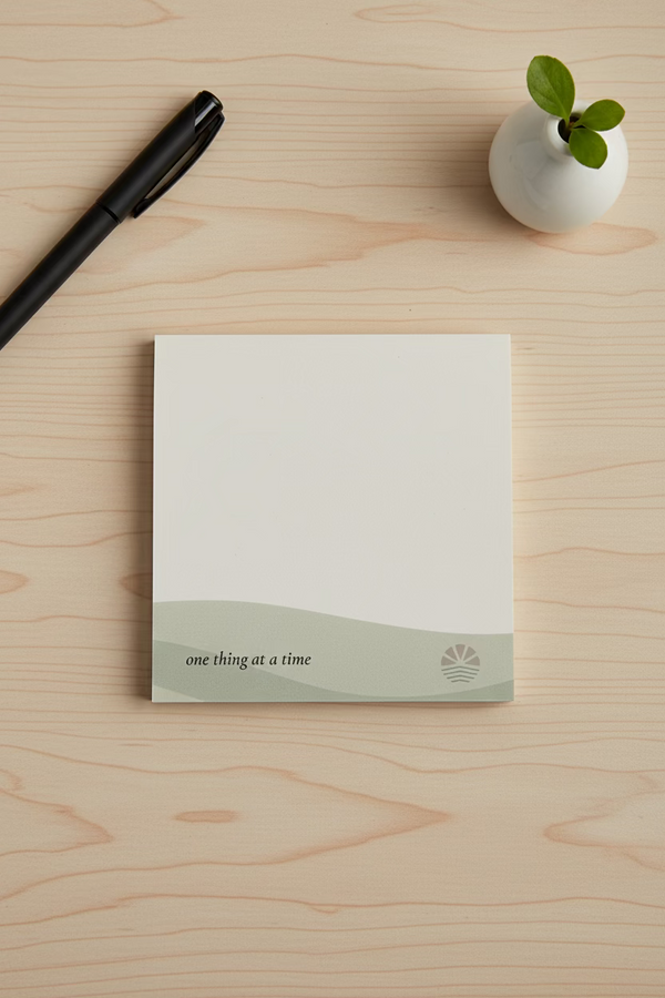 post it note page with sage green accent on the bottom with the phrase "one thing at a time". 