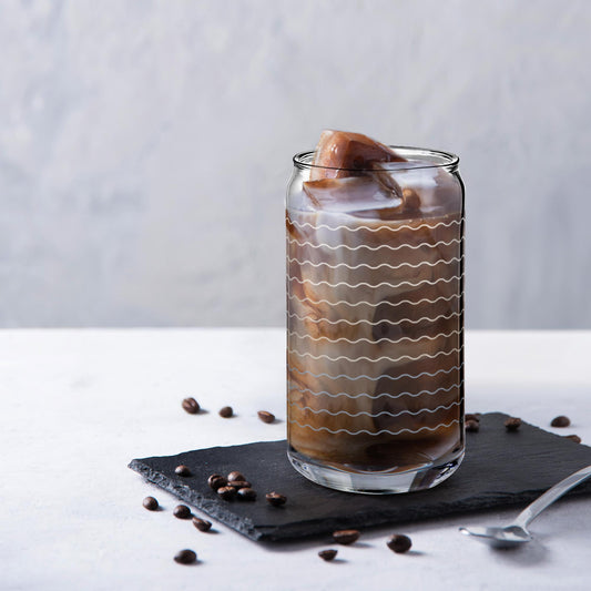 glass soda can cup filled with coffee with wave line decorations 